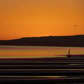 The sun sets over Camber Sands.