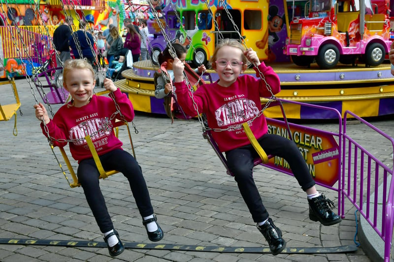 Charlotte Oakley, 4, and Keira Oakley, 6, of Boston enjoy a ride at the May Fair.