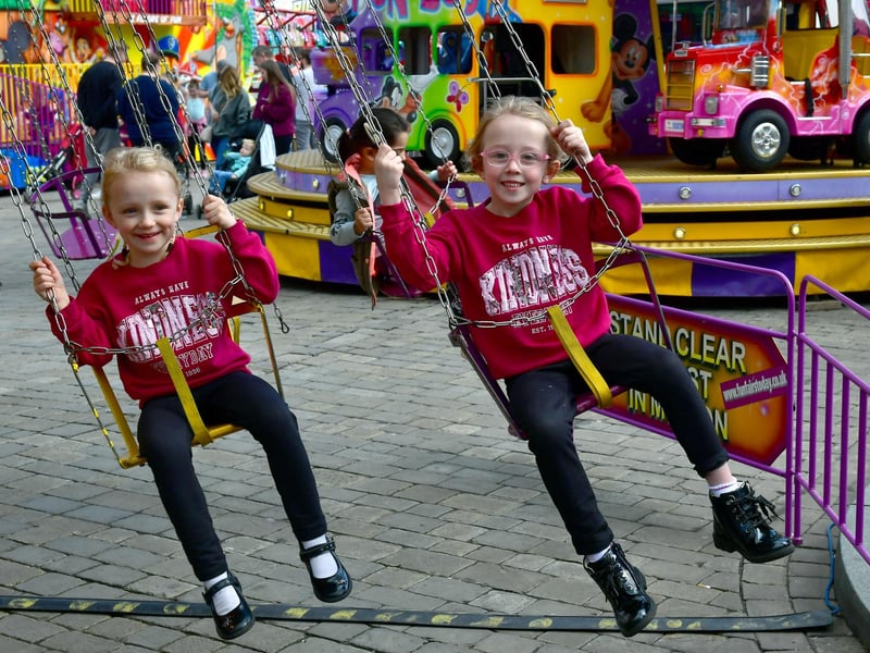 Charlotte Oakley, 4, and Keira Oakley, 6, of Boston enjoy a ride at the May Fair.