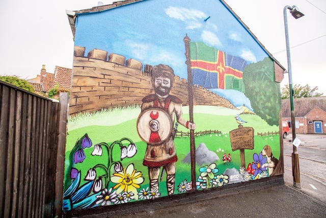 The finished mural on the St Lawrence Street toilets pays tribute to the town's Roman wall.