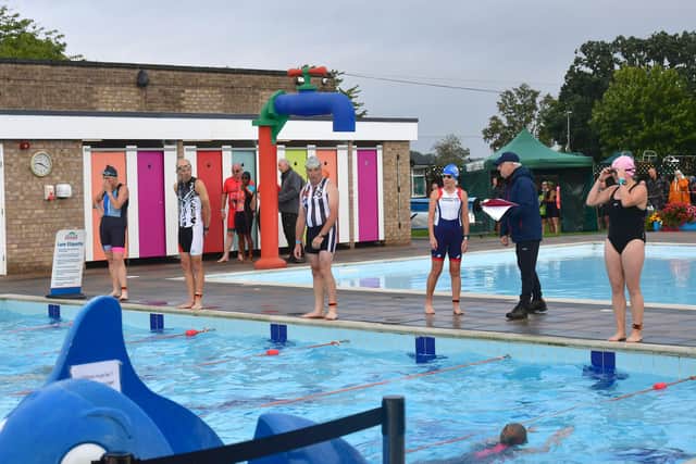 Swimmers in the triathlon ready to dive in.