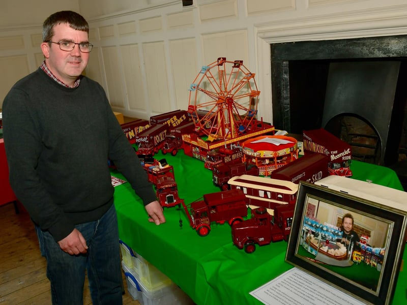 One of the organisers, Glyn Halgarth, with a tribute display of models made by Chris Hudson.
