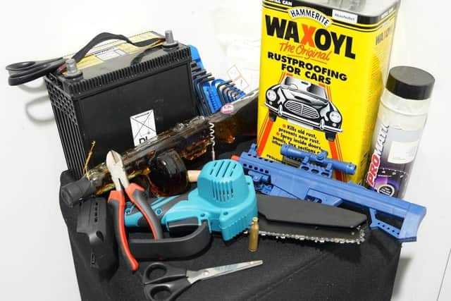 Some of the items recently confiscated by EMA security officers, including a chainsaw, rifle-shaped bottle of brandy, car battery, scissors, bullet casing and a tin of car wax