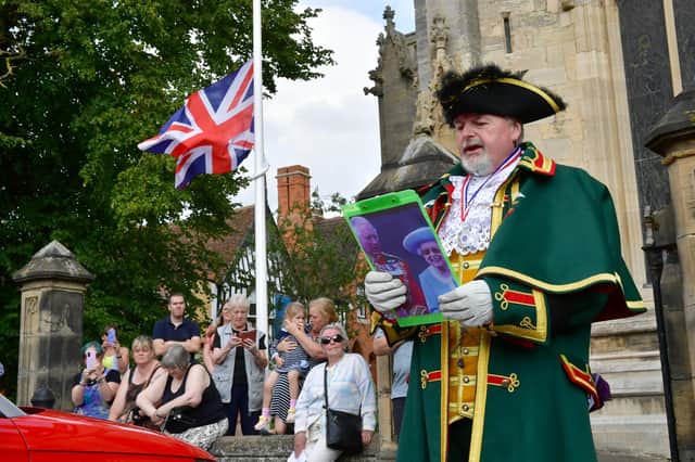 Sleaford Town Crier John Griffiths reading out the proclamation in Sleaford Market Place.