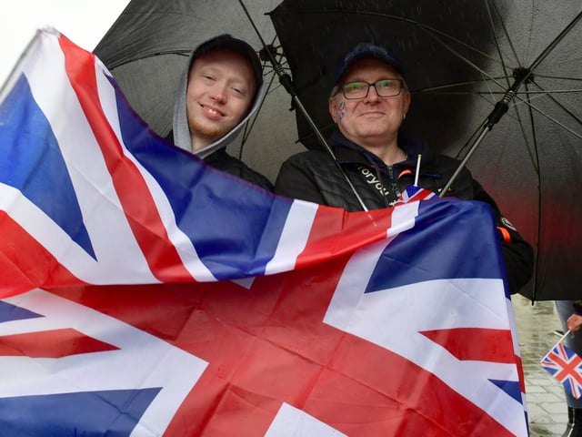 Laimonas Kazlauskas and Artctras Kazlauskas wave the Union Flag at the Jubilee Party in the Market Place yesterday (Sunday).