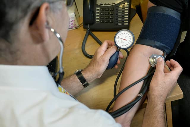 File photo dated 10/09/14 of a GP checking a patient's blood pressure. The majority of GPs are seeing patients over and above the "safe level" on a daily basis, a new survey suggests. Some 60% of family doctors say they see an average of 26-40 patients every day, according to a new survey by GP publication Pulse. Issue date: Monday August 21, 2023.