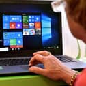 An elderly woman reads on a screen during a computer workshop. Image for illustration only. (Photo credit: GEORGES GOBET/AFP via Getty Images)