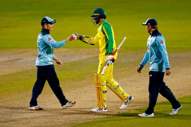 Australia's Mitchell Starc touches gloves with England's Captain Eoin Morgan after scoring the winning runs in the last over during the ODI at Old Trafford. (Photo by JASON CAIRNDUFF / POOL / AFP) .