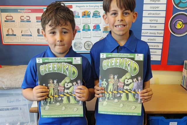 Children from Branston Junior Academy’s year 4 class - Isaac and Max - receiving their latest Green Kid comic.