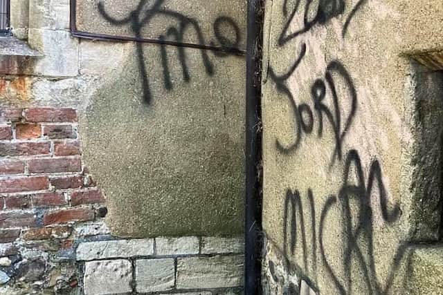 Graffiti on the wall of St Clement's Church, Skegness.