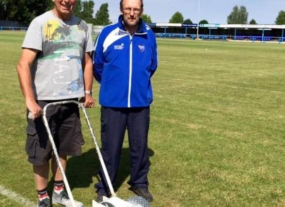 Jim Ely, left, pictured helping Boston Town secretary Eddie Graves with pitch maintenance in 2015.