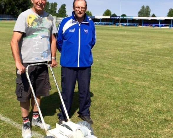 Jim Ely, left, pictured helping Boston Town secretary Eddie Graves with pitch maintenance in 2015.