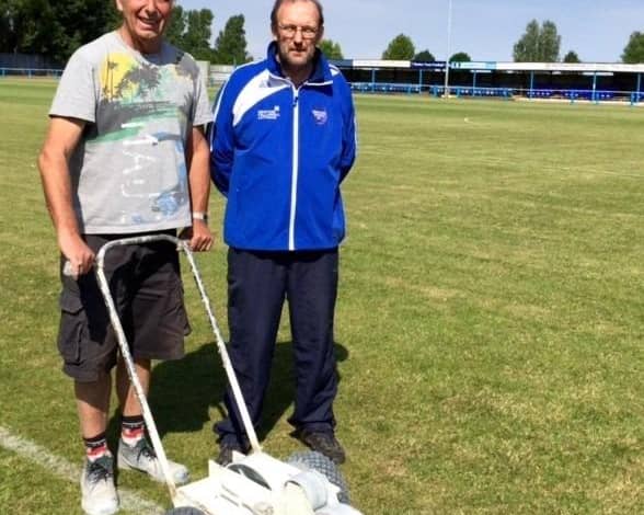Jim Ely, left, pictured helping Boston Town secretary Eddie Graves with pitch maintenance in 2015.