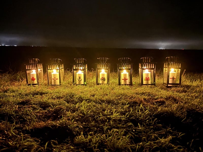 The lanterns on the seabank. The candles were personalised with symbols relating to the crew's homelands, with county symbols also in place for those from England.