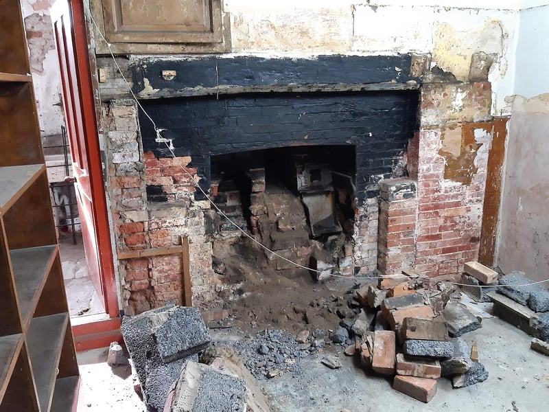 This large range was hidden behind shelving units, boards and concrete blocks. "It's too big for domestic use," said Shane, who wonders instead if it related to the beerhouse or perhaps the courtyard area and the buildings that once stood there or maybe even The Guildhall. Curiously, it has a lockable storage space above it.