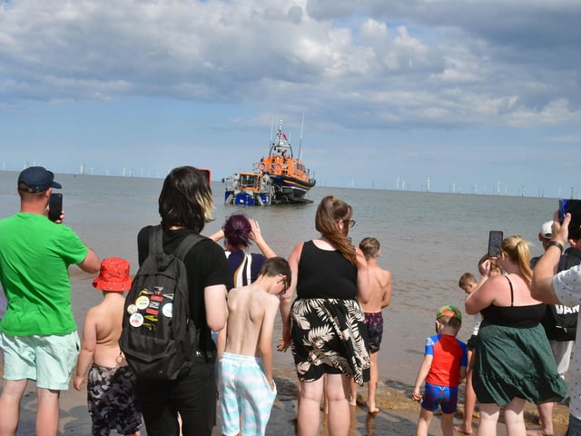 Spectators on the beach watching the lifeboats display.