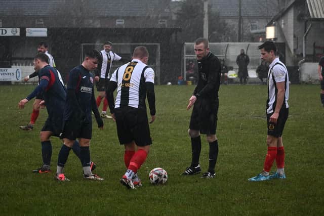 Rain soaks players and officials during Saturday's game at Brigg. Photo: Brigg Town FC.