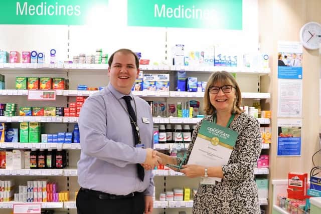 Alex from Lincolnshire Co-op Ruskington Pharmacy receiving his award from Jo Higham of Buttercups Training.