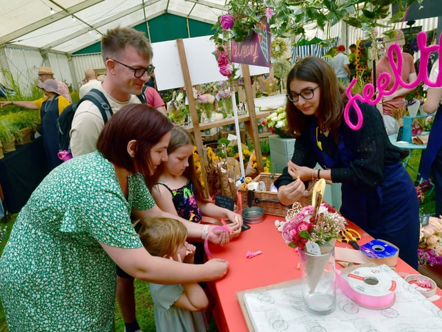 David and Becky Hartley of Sleaford with Sophie Hartley 8 and Charlotte Hartley 3, making ribbon rose ice creams, helped by Yasmin Ahmed of Evolve Flowers