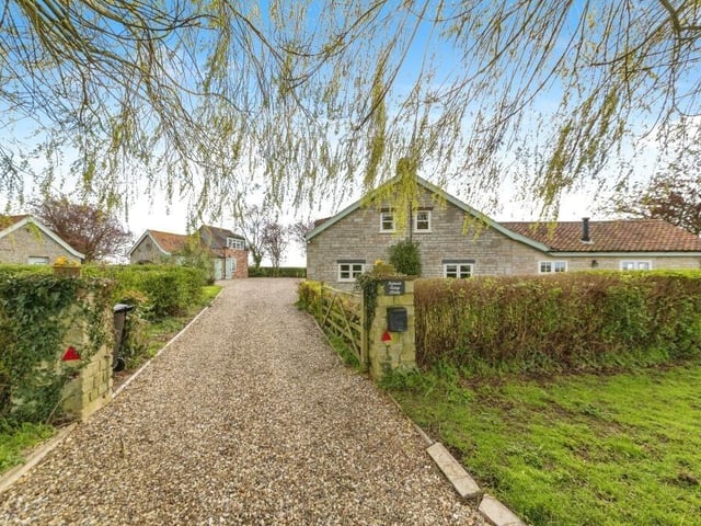 The drive leading to the home, on the right, and annexe, on the left.