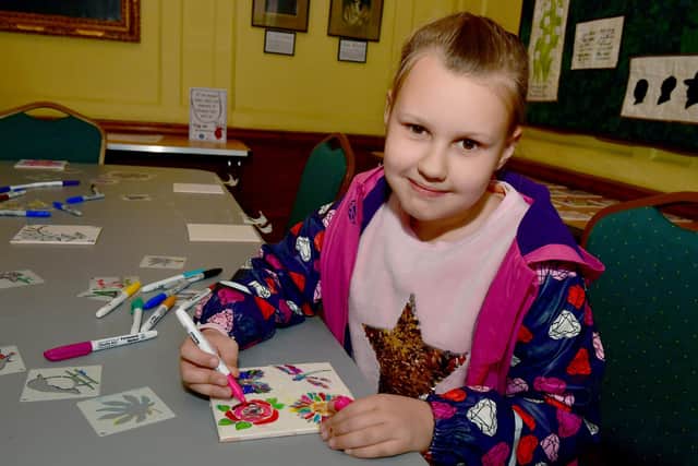 Angela Kearns, aged nine, of Boston, decorating Delft Tiles.