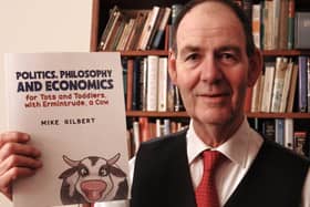 Coun Mike Gilbert with his book 'Politics, Philosophy & Economics for Tots and Toddlers'.
