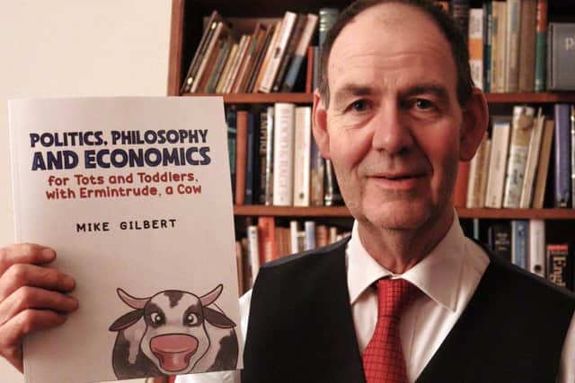 Coun Mike Gilbert with his book 'Politics, Philosophy & Economics for Tots and Toddlers'.