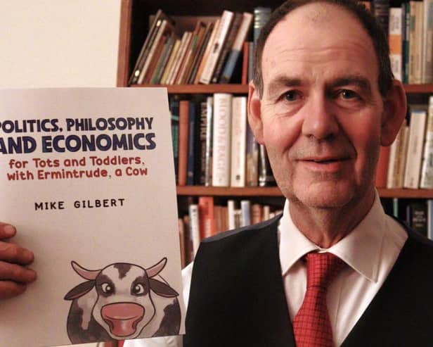 Coun Mike Gilbert with his book 'Politics, Philosophy & Economics for Tots and Toddlers'.