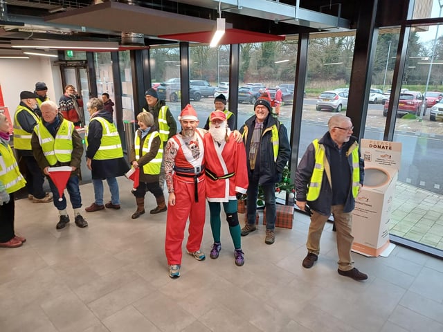 Rotarians gathered to act as stewards and help keep the Santas on track