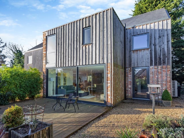 Decking outside a reception area at the front of the home, with access to the utility to the right.