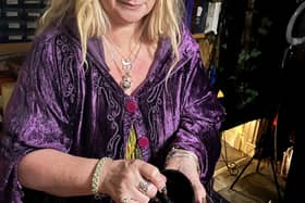 High Priestess Shelley Mayes mixes a potion.