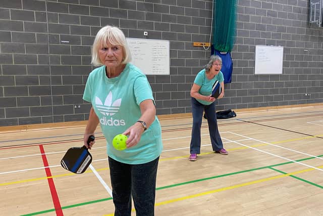 Sue Marshall and Jane Connor playing pickleball.