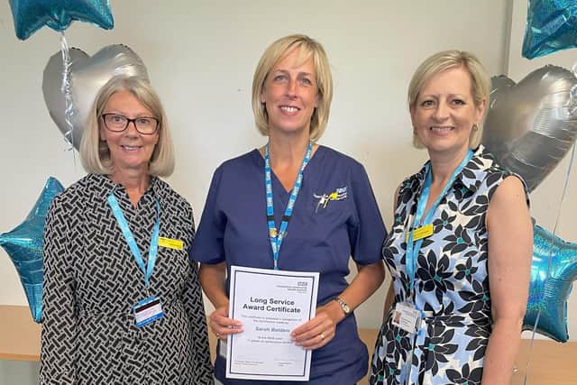 Sarah Baldam (centre) receiving her award from Elaine Baylis (left) and Professor Karen Dunderdale (right)