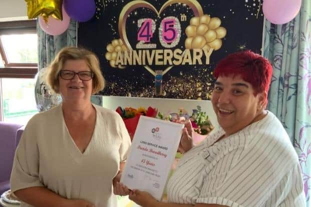 Brenda (L) received her long service certificate from Foxby Court Home Manager Sara Bland.