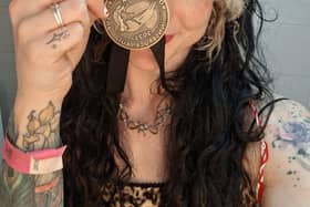 Lily proudly shows off her Bronze medal.