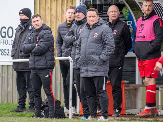 Skegness Town manager Chris Rawlinson (centre) is keen to see his side register their first win of the campaign.