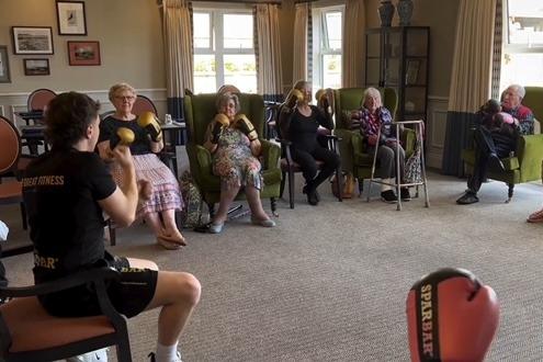 An instructor from Be Great Fitness leads the boxing session at Sleaford manor.