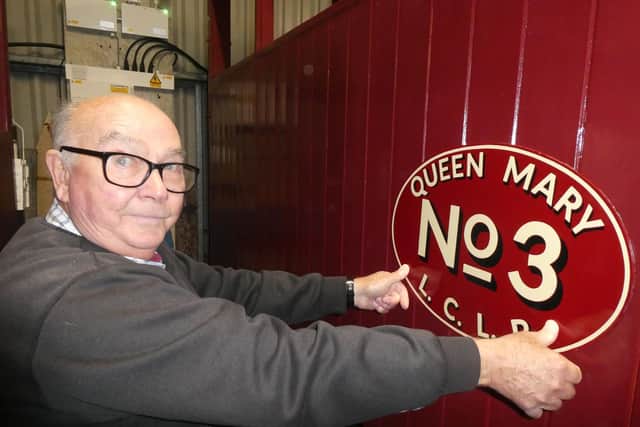 Mick Allen, who is doing much of the work on the carriage, with the ‘Queen Mary’ nameplates made by traditional signwriter Tim Fry . They t will be fitted for the 2023
season. (Photo © Chris Bates/LCLR).