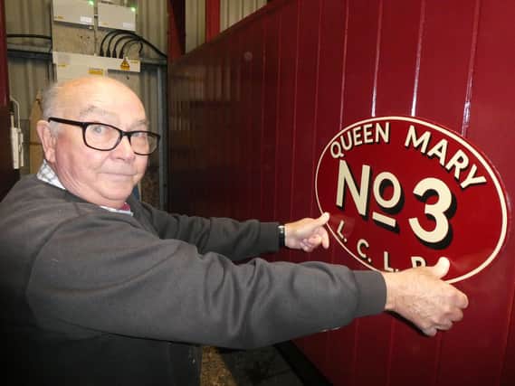 Mick Allen, who is doing much of the work on the carriage, with the ‘Queen Mary’ nameplates made by traditional signwriter Tim Fry . They t will be fitted for the 2023
season. (Photo © Chris Bates/LCLR).
