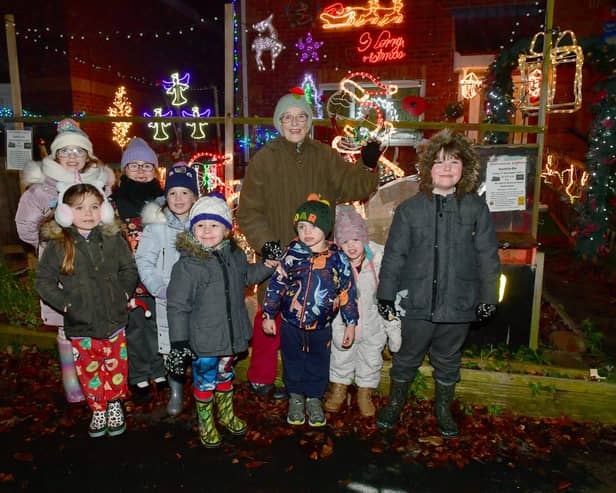 Elmtree Road home owner, Jacky Cooper with children and her lights. Photo: David Dawson
