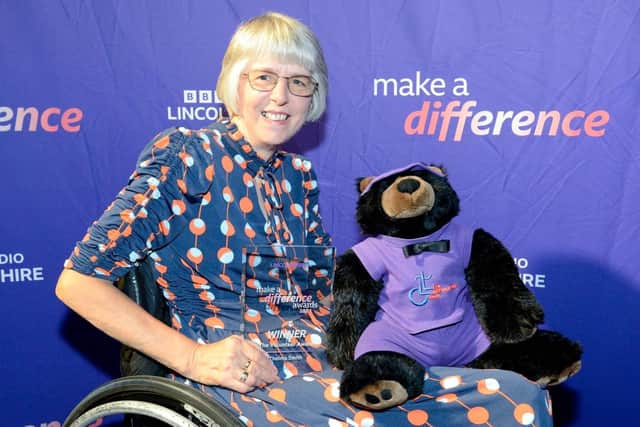 Thelma Smith with the Laffletics Club bear mascot. You can guess the name at the fundraiser on Saturday.