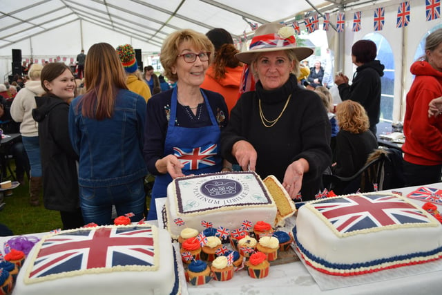 Bridget Turner and Gill Somerscales cut the celebration cakes ready for distribution