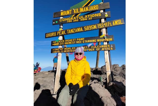 Joanne pictured at the summit of Mount Kilimanjaro.