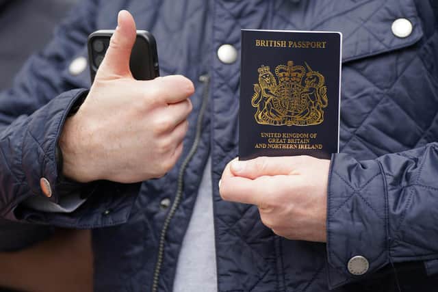 Alex Sladen holding his new passport in front of members of the PCS union on the picket line outside the Passport Office in east London, as more than 1,000 members of the Public and Commercial Services (PCS) union working in passport offices in England, Scotland and Wales begin a five week strike as part of the civil service dispute. Picture date: Monday April 3, 2023.