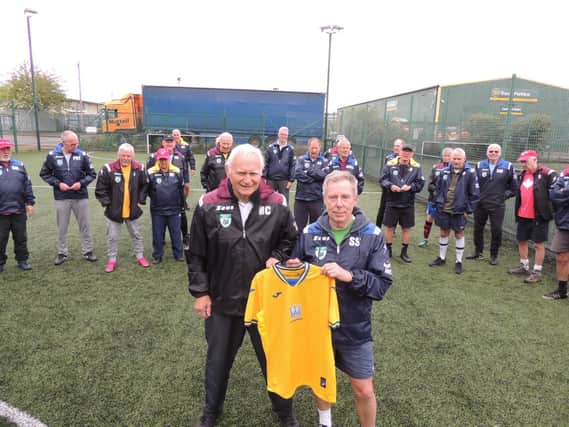 Mick Czopowyj with snails chairman Steve Spick and the Ukrainian shirt raffled off.