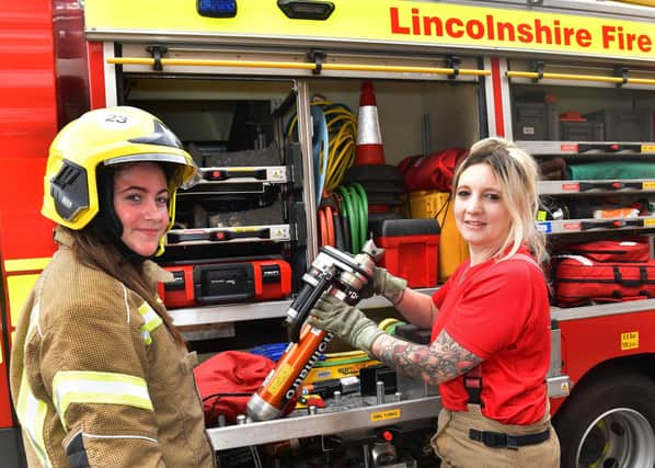 Firefighter Katie Mulligan explaining  about some of the equipment to Willow Van Landeghem. Photos: Mick Fox