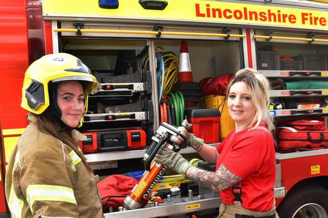 Firefighter Katie Mulligan explaining about some of the equipment to Willow Van Landeghem. Photos: Mick Fox