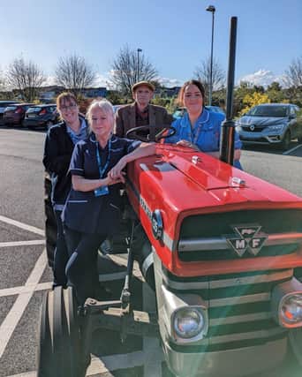 Colin and staff at Butterfly Hospice on the Massey Furguson tractor.