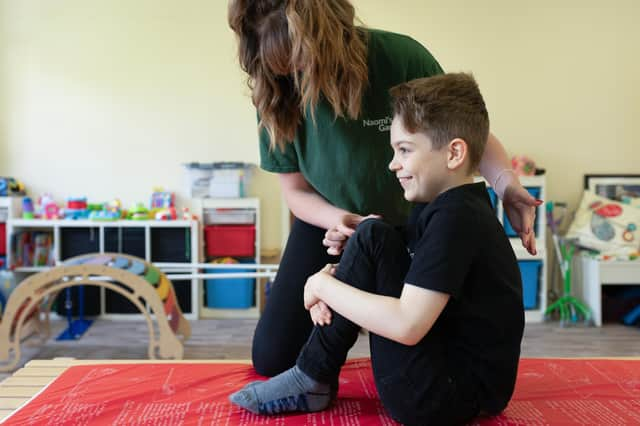 Naomi's Garden lead conductor Sarah-Jayne Walker helps a young client.