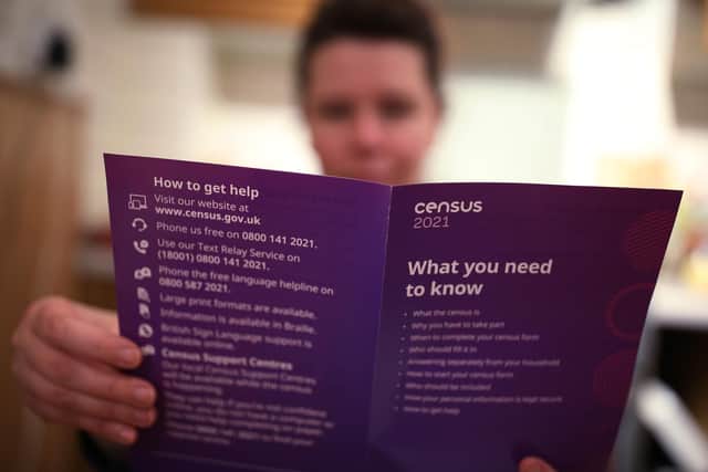 A woman reading a leaflet from the Office for National Statistics (ONS) containing information about The Census 2021, sent to households in England and Wales. Picture date: Monday March 22, 2021.
